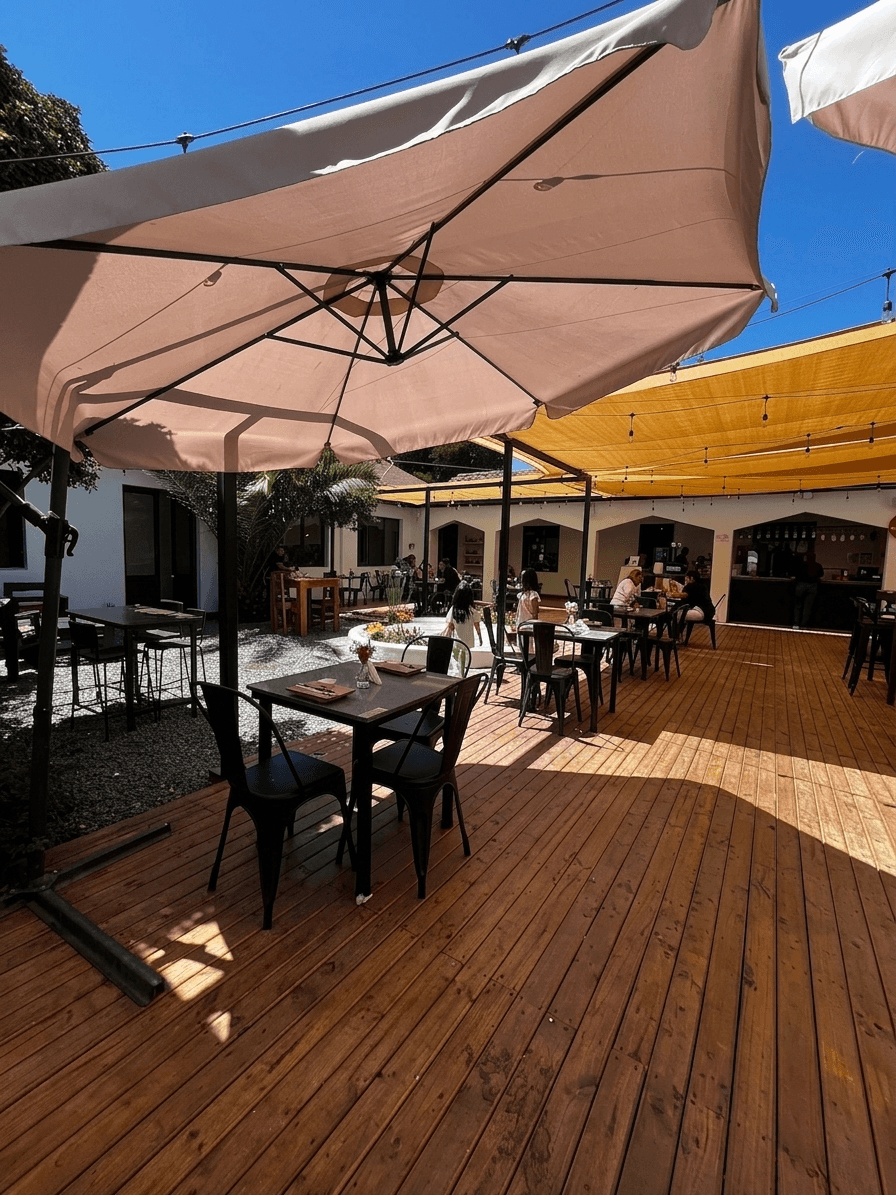 Terraza exterior de TAKE'S con mesas y sombrillas